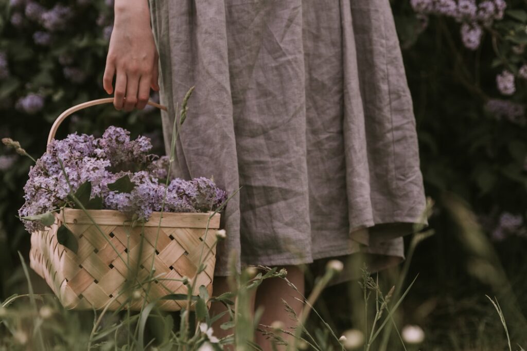 a woman holding a basket with flowers in it