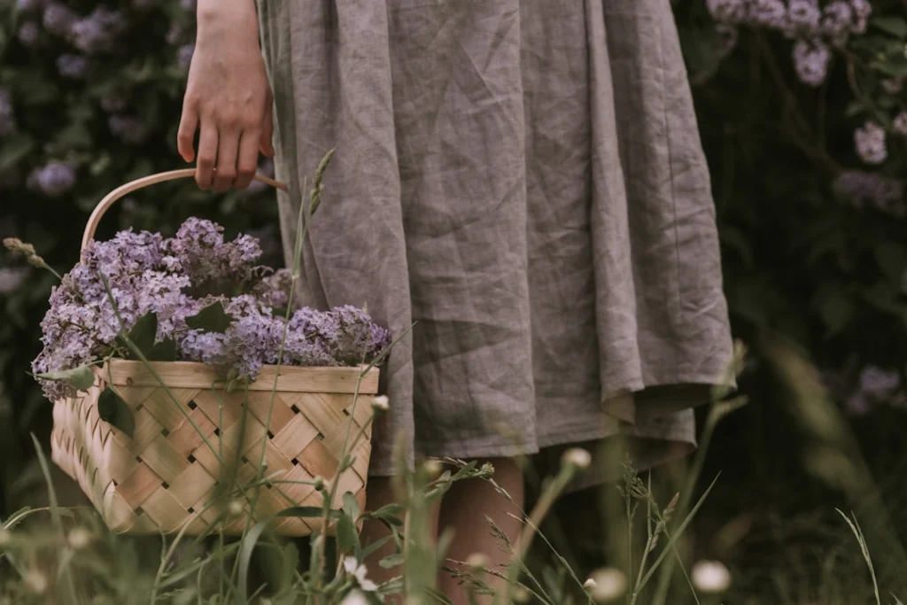 a woman holding a basket with flowers in it