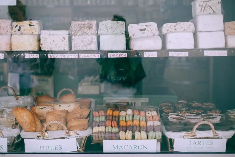 Assorted yummy sweets and bakery products places on counter of confectionery shop in daytime